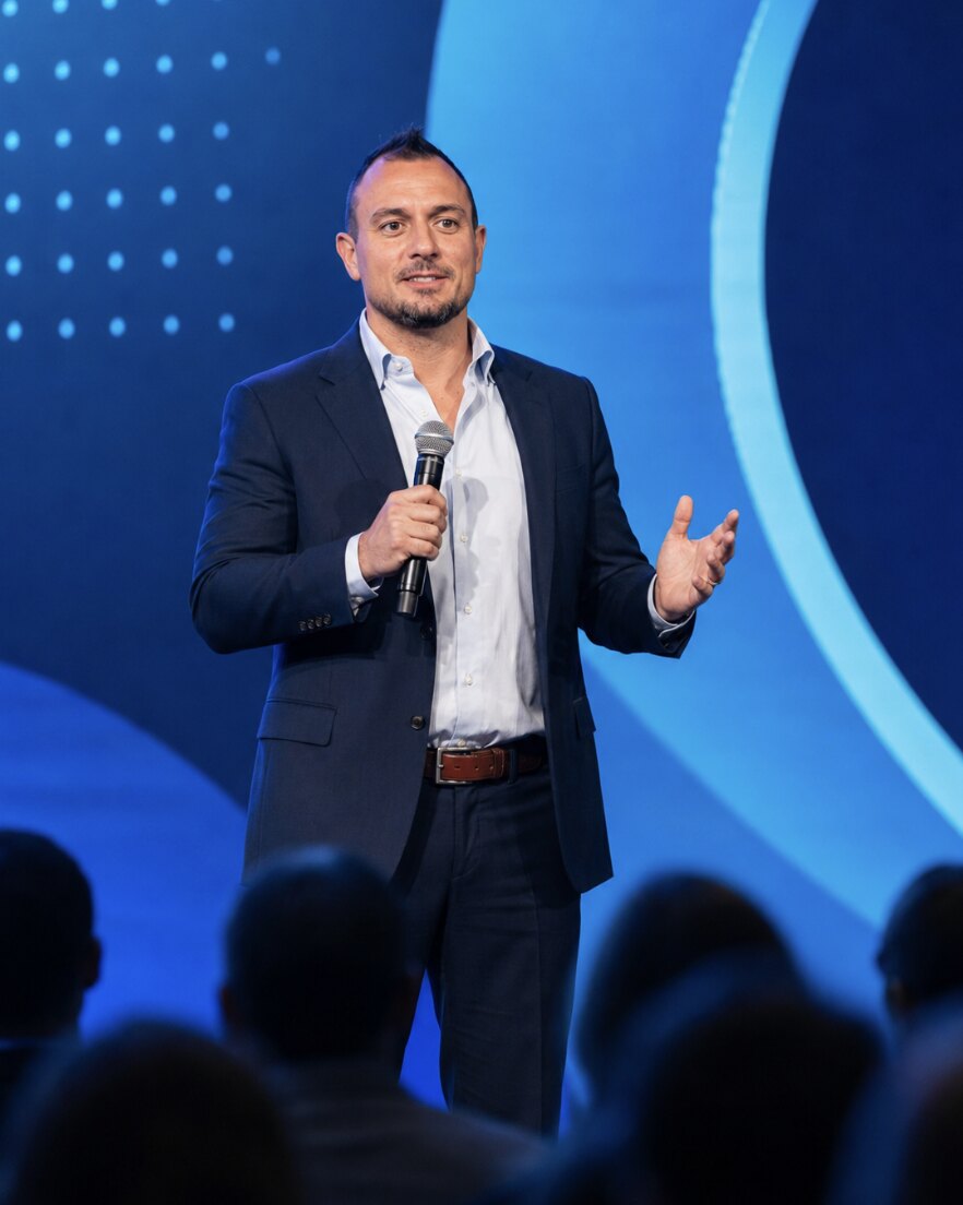 Justin Thomas delivering a keynote on stage